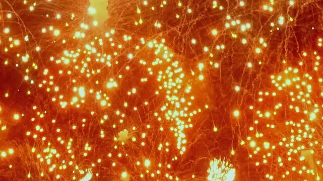 Vibrant explosion of colors fills night sky as dazzling fireworks illuminate urban landscape. Each burst creates magical atmosphere, captivating onlookers with breathtaking patterns and brilliance.