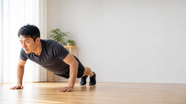 Home workout push-ups fitness concept with middle aged Japanese man and copy space