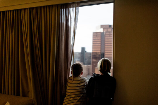 Brothers Looking Out Hotel Window in Downtown Phoenix, Arizona