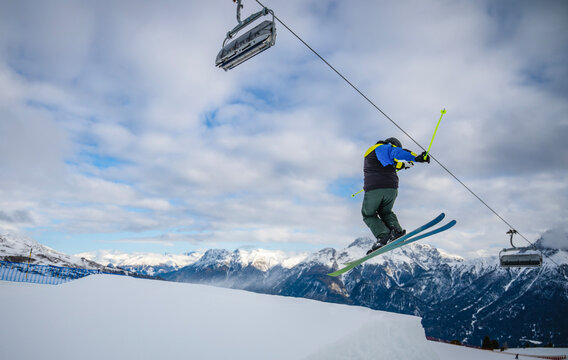 freestyle skier jumping over ramp in Scuol / Switzerland