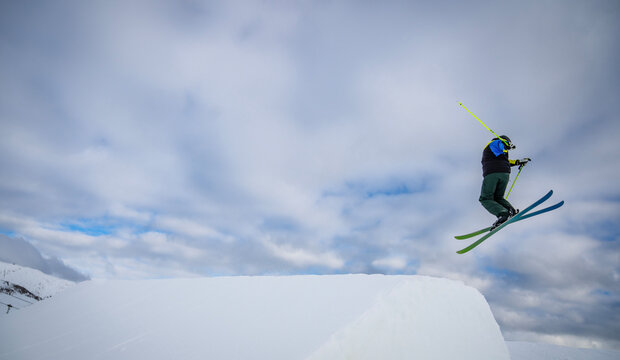 freestyle skier jumping over ramp in Scuol / Switzerland