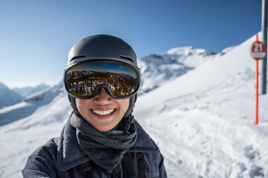 portrait of woman wearing ski googles at Scuol winter sport area
