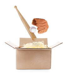 Baseball bat, glove and ball falling into cardboard box with shredded paper filler on white background