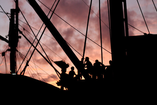 Sailing into Twilight: Silhouettes of Pinisi Crew at the Historic Sunda Kelapa Harbour