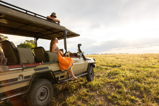 teen girl and brother on safari vehicle,family on mobile safari, Okavango Delta, Botswana, Africa