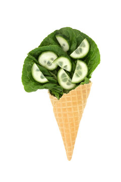 Surreal lettuce leaf cucumber ice cream cornet fun diet concept on white background. Healthy summer green organic nutritious vegetable food art design.