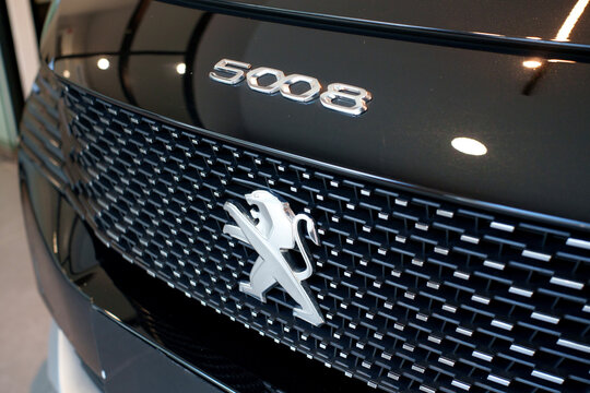Penang, Malaysia - Apr 07, 2026: A close-up view of the front section of a black Peugeot 5008 SUV, showing the chrome 5008 model designation and the classic Peugeot lion emblem.