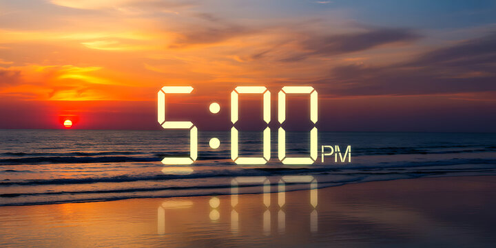 Digital clock display showing 500 PM at sunset by the ocean