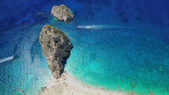Spectacular view of Mizithres sea stacks and white limestone cliffs in Zakynthos. Crystal turquoise water and dramatic coastline of the Ionian Sea in a scenic Greek island landscape.
