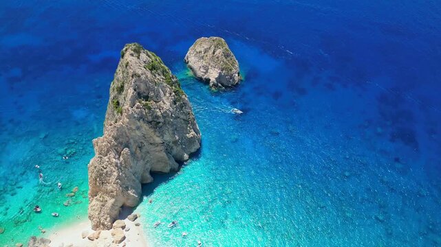 Spectacular view of Mizithres sea stacks and white limestone cliffs in Zakynthos. Crystal turquoise water and dramatic coastline of the Ionian Sea in a scenic Greek island landscape.