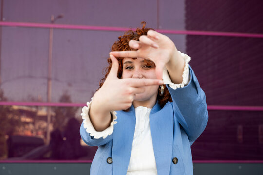 Entrepreneur making a finger frame gesture outdoors in Granada