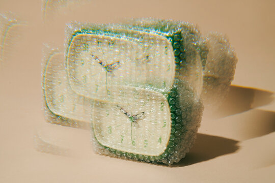 Alarm clock wrapped in bubble wrap with kaleidoscopic distortion