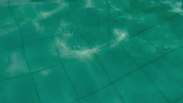 Clear Blue Water in Pool with Sunlight Reflections