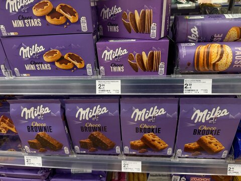 Palma, spain, may 2, 2026, milka chocolate cookies, brownies, and brookies on retail store shelf, offering popular sweet snacks