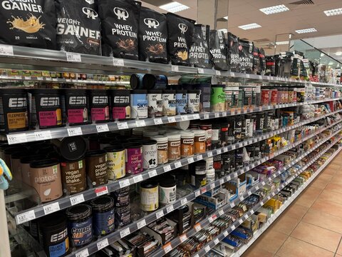 Palma, spain, may 2, 2026, supermarket aisle filled with shelves of various sports nutrition, protein, and health supplements, catering to active lifestyles