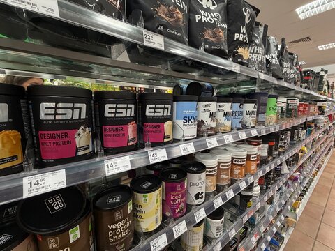 Palma, spain, may 2, 2026, sports nutrition protein powders and supplements filling shelves in a modern supermarket aisle for fitness enthusiasts