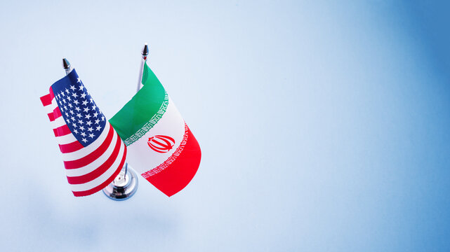 Flags of America and Iran close up isolated on background. Trade intensions between US and Iran concept.
