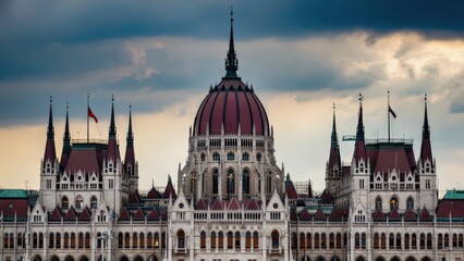 Obraz premium Stunning Budapest Parliament Building illuminated at dusk, showcasing iconic Neo-Gothic architecture and intricate details against a vibrant evening sky.