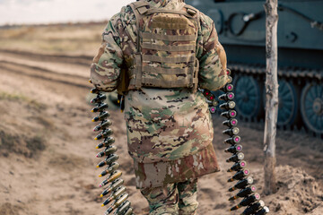 Naklejka premium machine gun belt for air defense in the hands of a soldier
