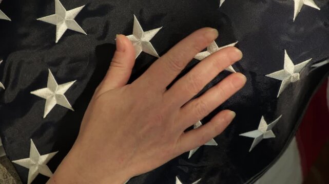 Man's hand touching American flag close-up