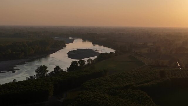 Po River near Spinadesco Cremona Lombardy Italy with low water level exposing sediment bar and reduced flow within alluvial floodplain during dry spring conditions linked to climate variability aerial