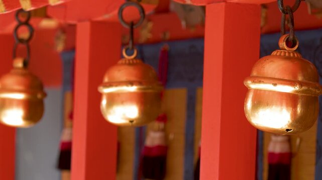 Traditional Brass Suzu Bells Hanging at a Shinto Shrine in Kyoto