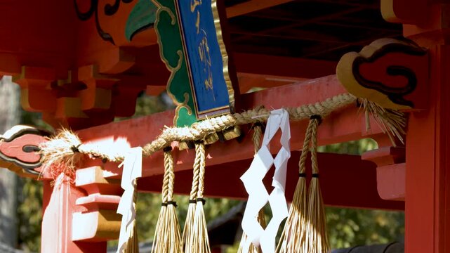 Vermilion Shinto Shrine Gate with Shimenawa Rope and Paper Streamers