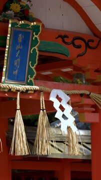 Traditional Vermilion Shinto Shrine Gate with Shimenawa Rope in Kyoto