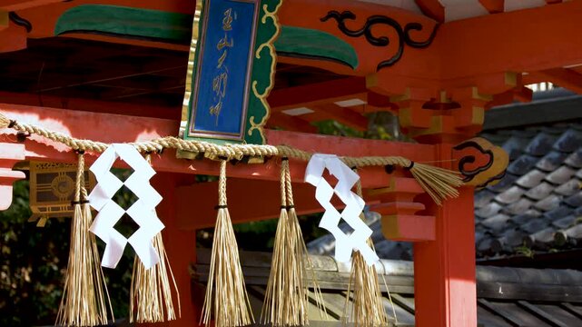 Traditional Shinto Shrine Gate with Shimenawa Rope and Shide in Kyoto