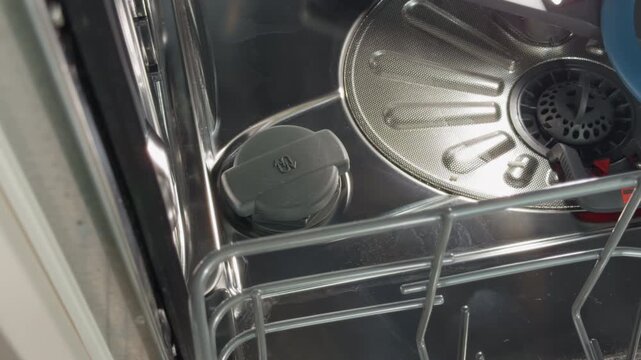 Dishwasher component overview. Detailed view of dishwasher lower compartment with removable features