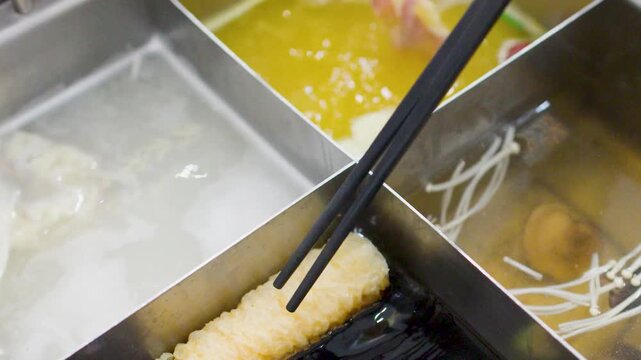 Dipping Meat and Vegetables into Boiling Chinese Hot Pot Soup Bases