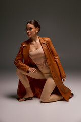 Stylish young woman showcases bold fashion in a modern studio setting