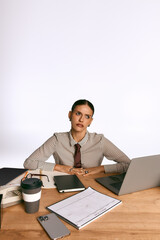 Fototapeta premium Stylish young woman in glasses works passionately in a modern office setting