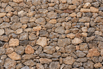 Fototapeta premium Stone wall showing rustic masonry texture background pattern