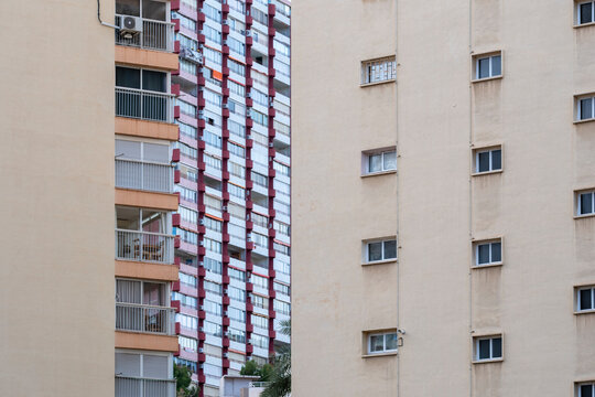 Minimal negative space with balcony geometry and abstract pattern on urban apartment building facade architecture in spain for modern residential exterior detail