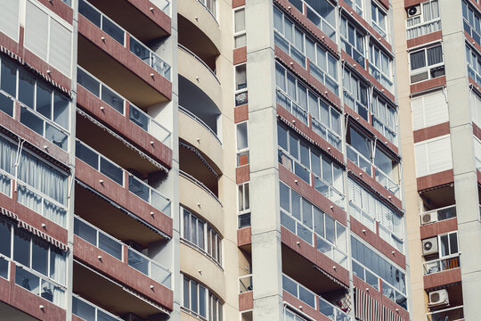 Stacked rectangle balcony geometry forms abstract pattern on urban apartment building facade architecture in spain with modern residential exterior detail