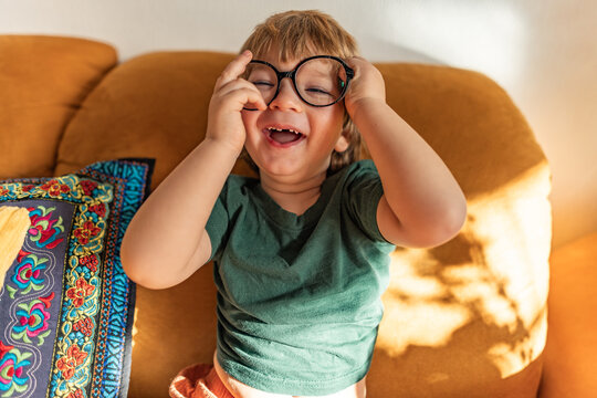 Happy child with eyewear playing indoors during spring