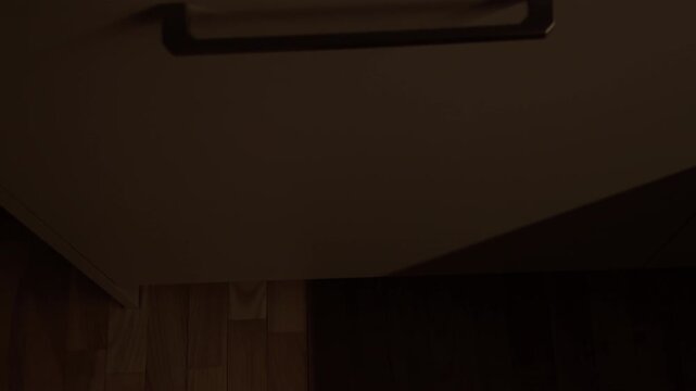 Male hand closes dishwashing machine and it emmits red dot, starts it's cycle