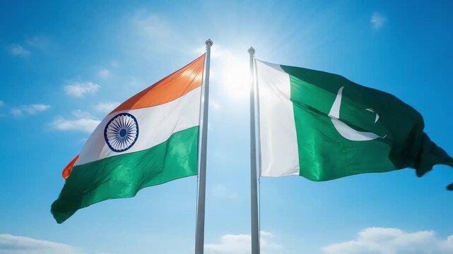 state flags of india and pakistan wave in the wind under bright sunlight. high quality footage emphasizes the details of the fabrics and the symbolism of the two countries.