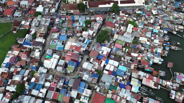 Drone aerial footage of densely populated residential neighborhood in Cebu City, Philippines, showing compact urban housing and city infrastructure.