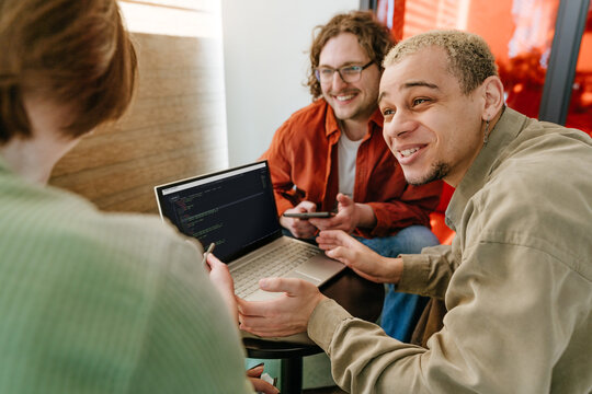 Smiling programmers working together as a team in the office