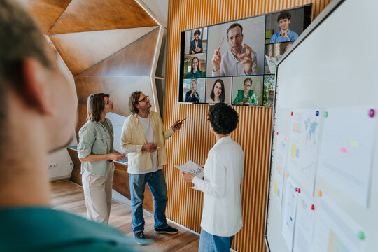 Business colleagues discussing during video call in modern office