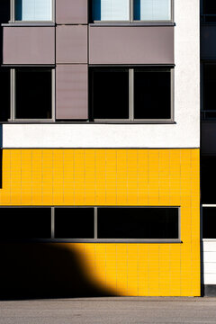 Color contrast tiles and window on a modern minimalist building facade create geometric architecture lines for clean graphic exterior design