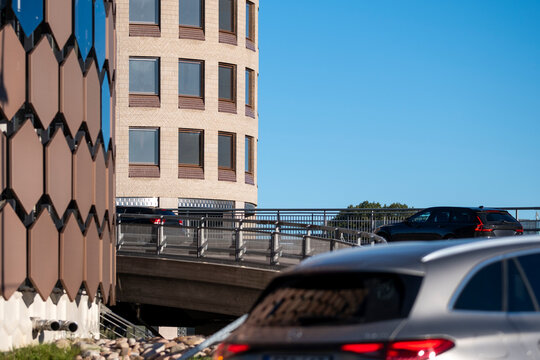 Cars in traffic on bridge roadway in Stockholm Sweden with urban infrastructure skyline in daylight illustrating modern city mobility network
