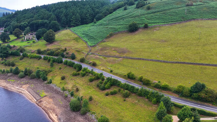 Naklejka premium Aerial View of a Rural Road Beside a Reservoir in Derbyshire