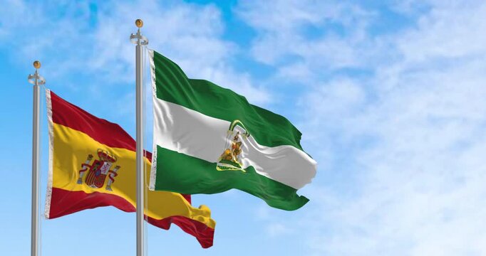 Flags of Andalusia and Spain waving together on a clear day. Seamless 3d render animation. Slow motion loop. Selective focus