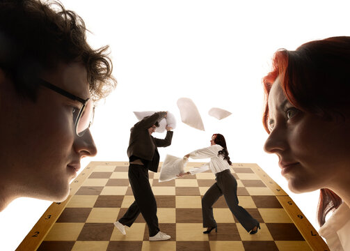 Business leaders observing miniature employee pillow fight on chess board. Concept of workplace rivalry, leadership pressure, team dynamics and corporate strategy.