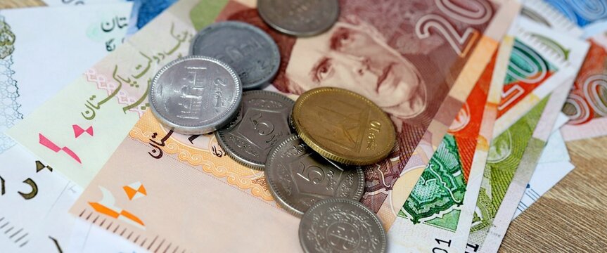 Pakistani rupee money bills and coins on table. Pakistan cash of PKR currency close up