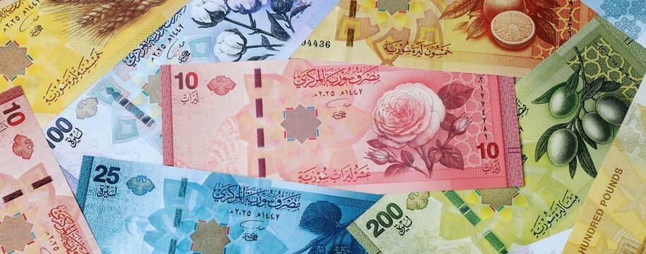 Syrian pound money banknotes bunch on table. Syria bills of SYP currency close up