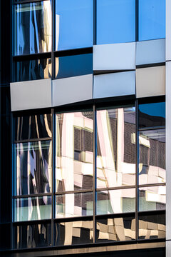 Fragmented modern architecture facade building glass reflection windows creating abstract pattern geometry with mosaic distortion irregular grids and sharp angles